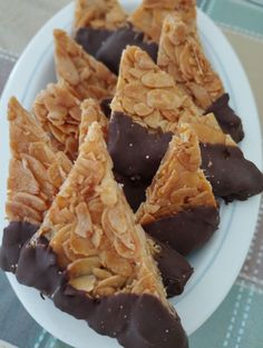 several pieces of chocolate covered dessert on a plate