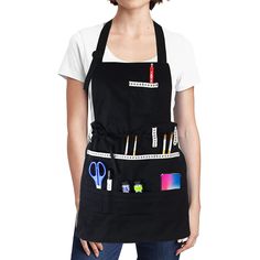 a woman wearing an apron with scissors and other items on it's back pocket