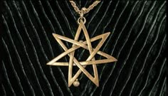 a gold necklace with a star on it