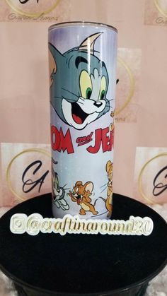 an image of a cartoon character on a coffee cup with the name tom and jerry