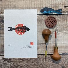 an assortment of woodworking tools on top of a wooden table next to a piece of paper