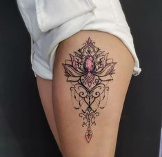 a woman's thigh with a tattoo design on the lower part of her leg