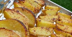 cooked potatoes sitting on top of tin foil in a pan, ready to be eaten