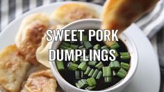 sweet pork dumplings in a white bowl with green onions and dipping sauce on the side