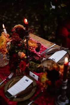 the table is set with candles and place settings