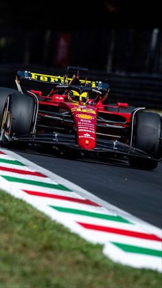 a red race car driving down the track