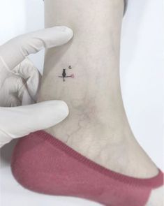 a person with a small tattoo on their ankle