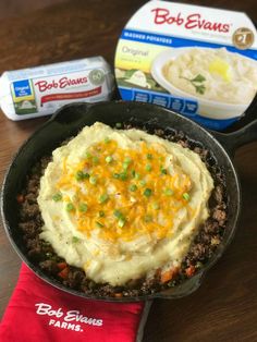 mashed potatoes and beef entree in a cast iron skillet on a wooden table