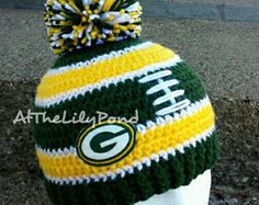 a green bay packers knitted hat on top of a mannequin head