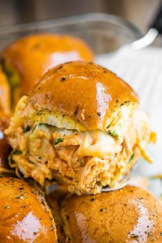 a pile of chicken sliders sitting on top of each other in front of a bowl