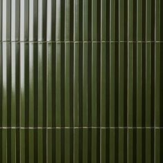 a green wall with vertical lines on it