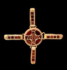 an antique gold and red glass cross