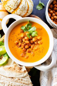 a white bowl filled with chickpeas and garnished with cilantro