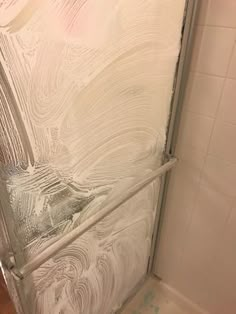 the shower door is covered in frosted glass and has no curtain on it's side