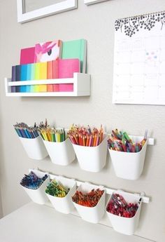 the wall is filled with different colored pencils and markers