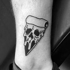 a black and white photo of a slice of pizza on the ankle with a skull