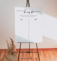 a white sign sitting on top of a wooden easel