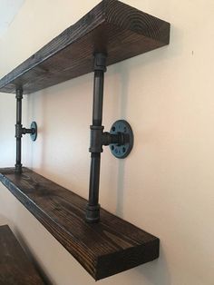 two wooden shelves with metal pipes on them