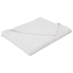 the white blanket is folded up on top of a tablecloth with an open end