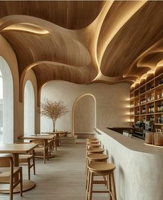 the interior of a restaurant with wooden tables and stools