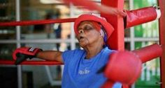 a woman in blue shirt and red boxing gloves