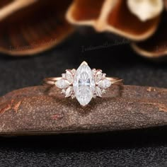 a diamond ring sitting on top of a piece of wood