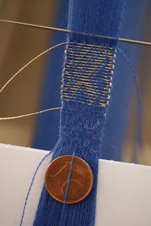 a penny sitting on top of a blue piece of fabric