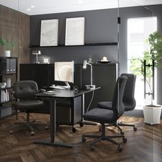 an office with two chairs and a desk in the middle, on top of a hard wood floor