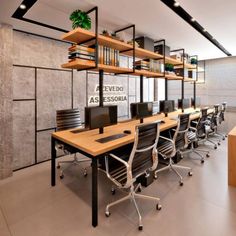 an empty conference room with desks and bookshelves on the wall above them