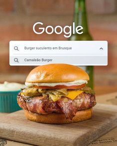 a hamburger sitting on top of a wooden cutting board next to a bottle of beer