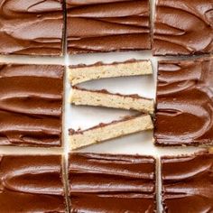 chocolate frosted cake cut into squares on a white surface