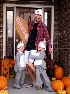 a man and two children are dressed in costumes