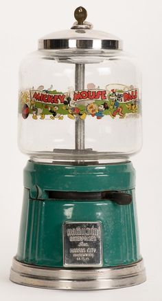 a gummy machine sitting on top of a white table next to a green stove