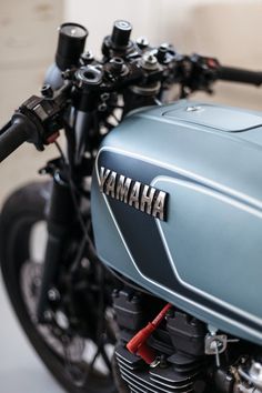 a blue yamaha motorcycle parked in a garage