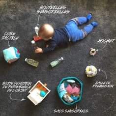 a baby laying on the floor with its contents labeled in english and spanish, including toys such as an infant's diaper