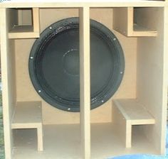 a large speaker sitting inside of a wooden box