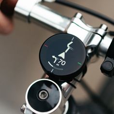 a close up of a bike handlebar with a speedometer on the front wheel