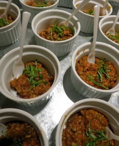 several bowls filled with food sitting on top of a table