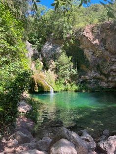 a small lake surrounded by trees and rocks