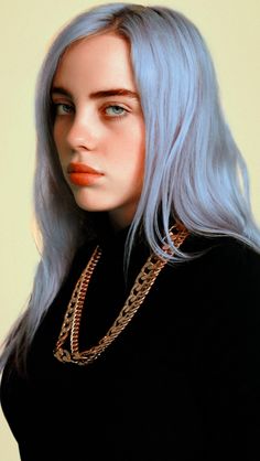 a woman with blue hair wearing a black shirt and gold chains on her neck is looking at the camera