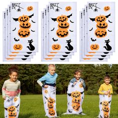 four children in halloween costumes standing next to each other with pumpkins and bats on them