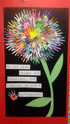 a flower made out of handprints on a bulletin board with the words, we are