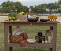 a picnic table with food and drinks on it