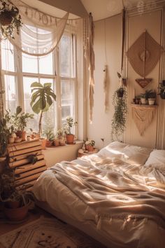 an unmade bed in a bedroom with plants on the window sill and potted plants