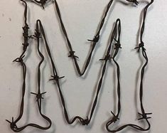 barbed wire is arranged into the letter m