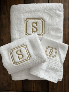 three white towels with the letter s on them