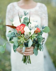 a woman holding a bouquet of flowers in her hands