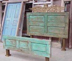 an old wooden bed with blue doors and wings