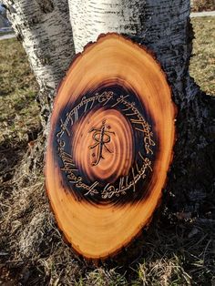 a tree that has been cut down and is decorated with an image of a cross on it