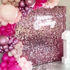 balloons and confetti decorate the entrance to a birthday party